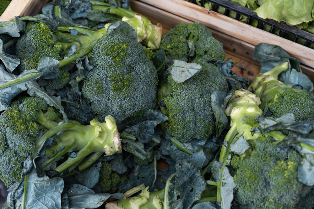 a pile of broccoli sitting on top of a wooden crate