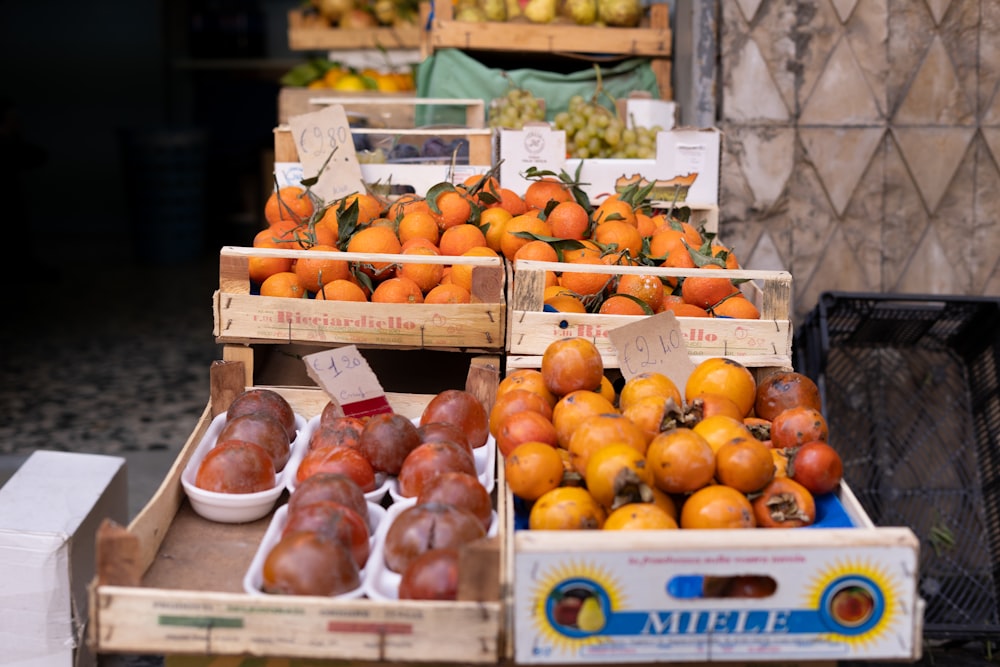 a fruit stand with oranges, pears and other fruit
