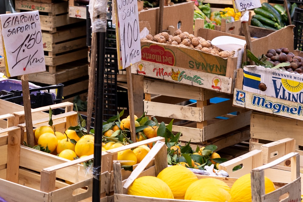 a bunch of crates filled with lots of fruit