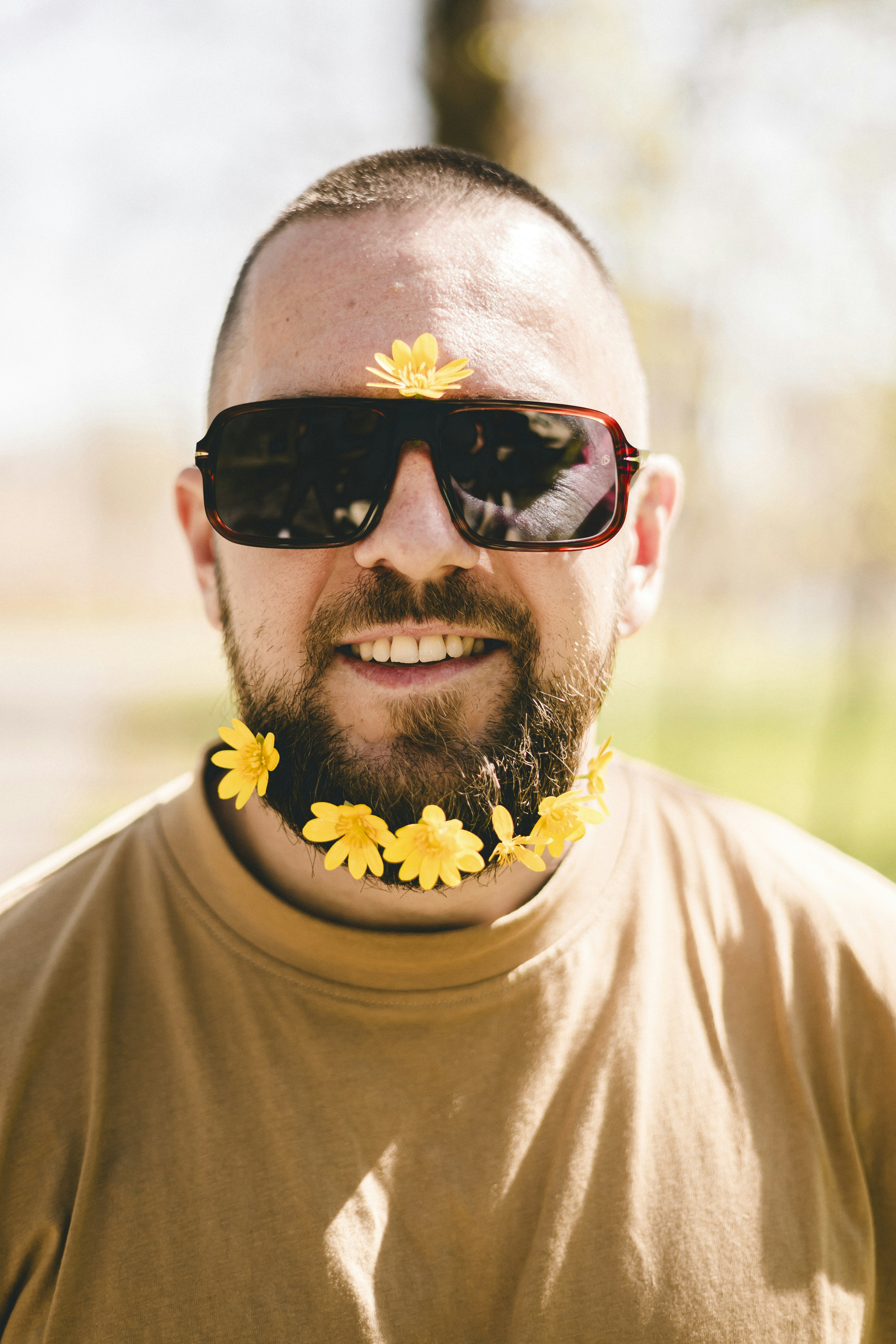 a man with sunglasses and a flower in his hair