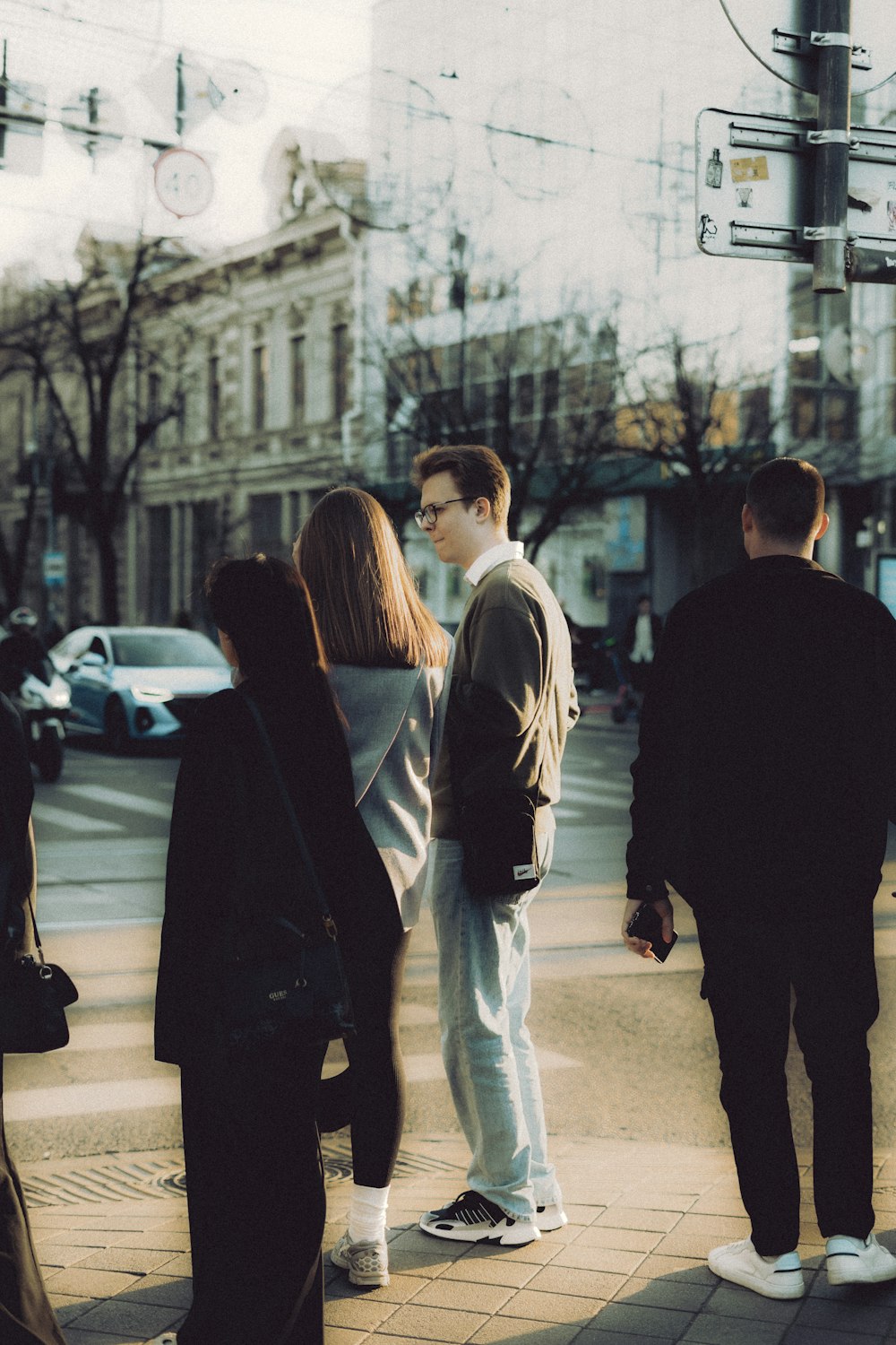 a group of people standing on the side of a road