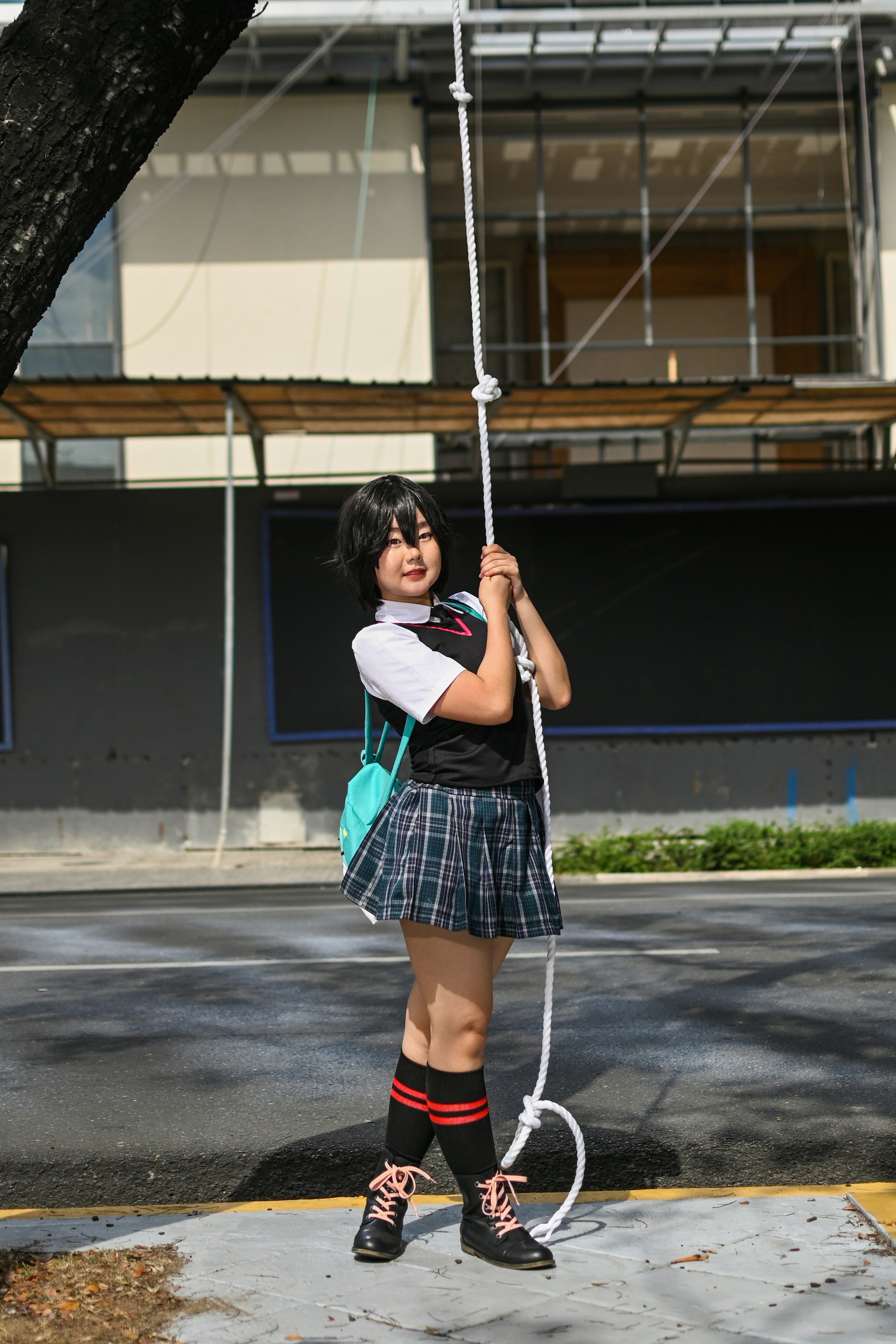 seorang gadis berseragam sekolah memegang tali