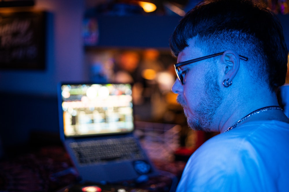 a man sitting in front of a laptop computer