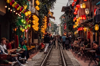 a group of people walking down a train track