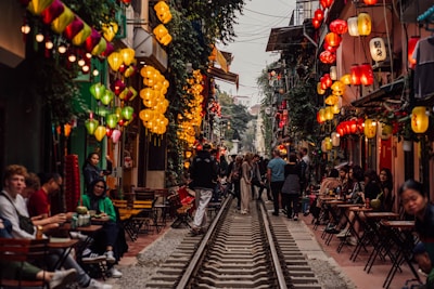 a group of people walking down a train track