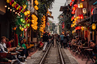 a group of people walking down a train track