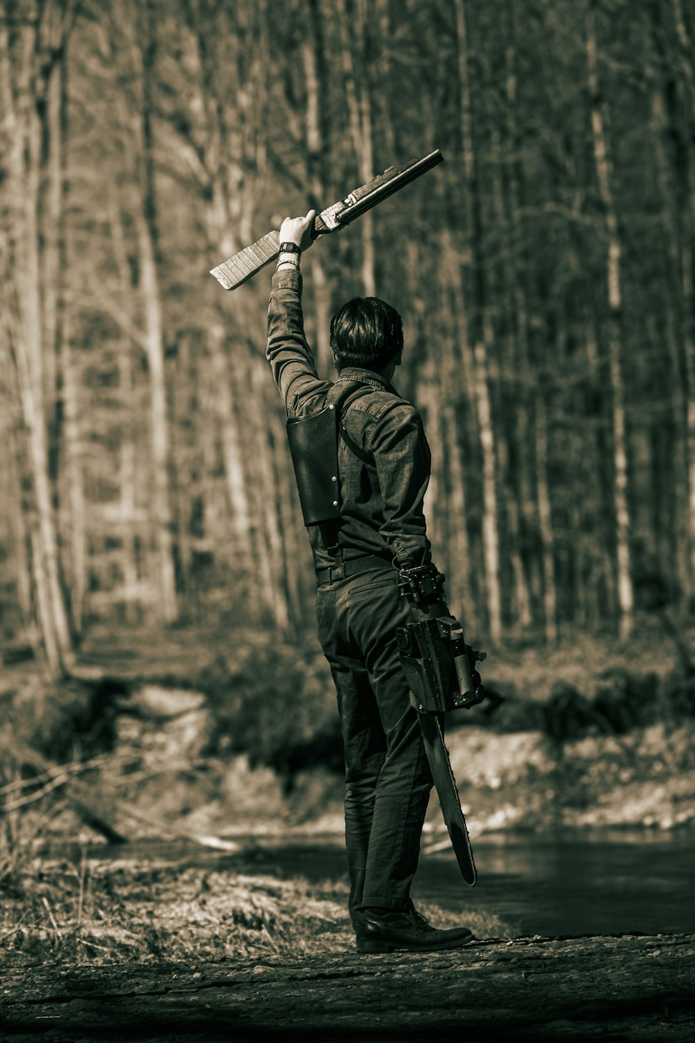 a man holding a rifle up in the air