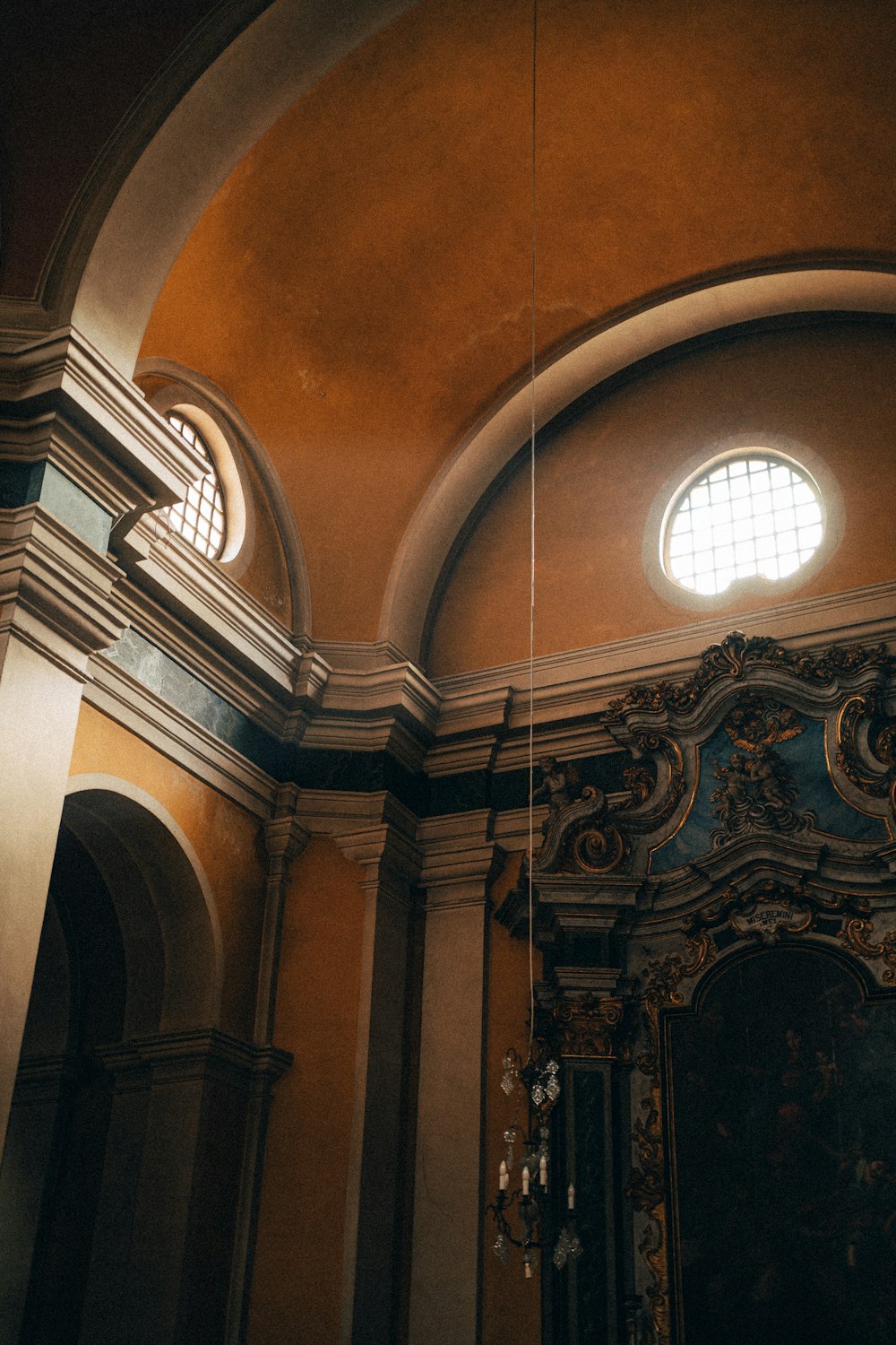 a large room with a ceiling and two round windows