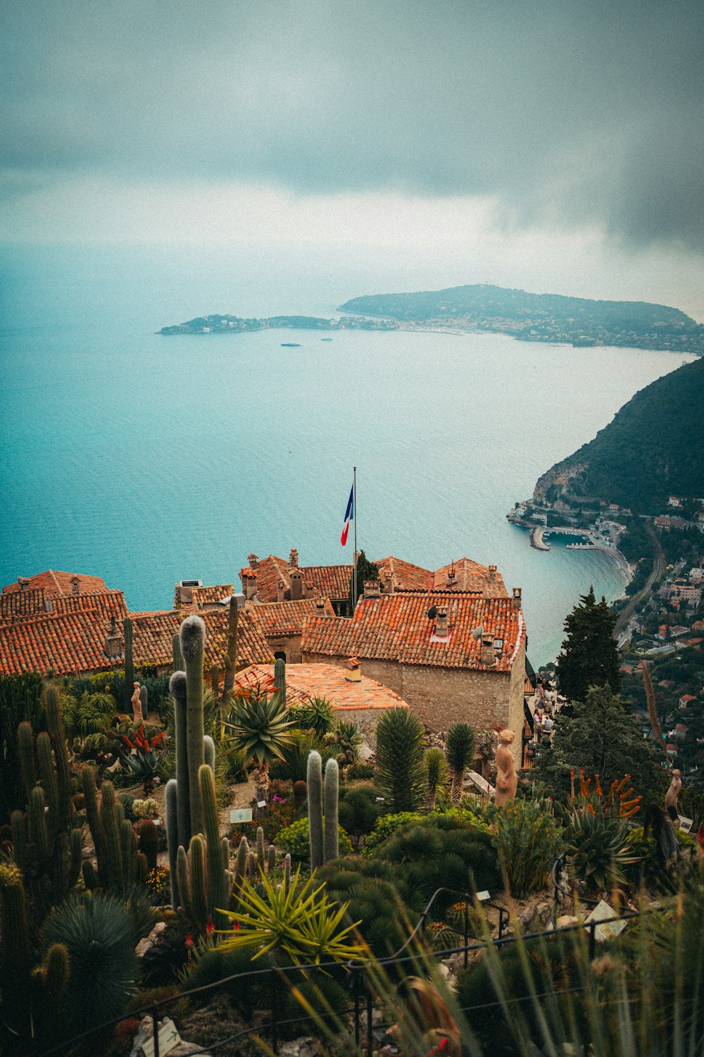 a large body of water sitting next to a lush green hillside