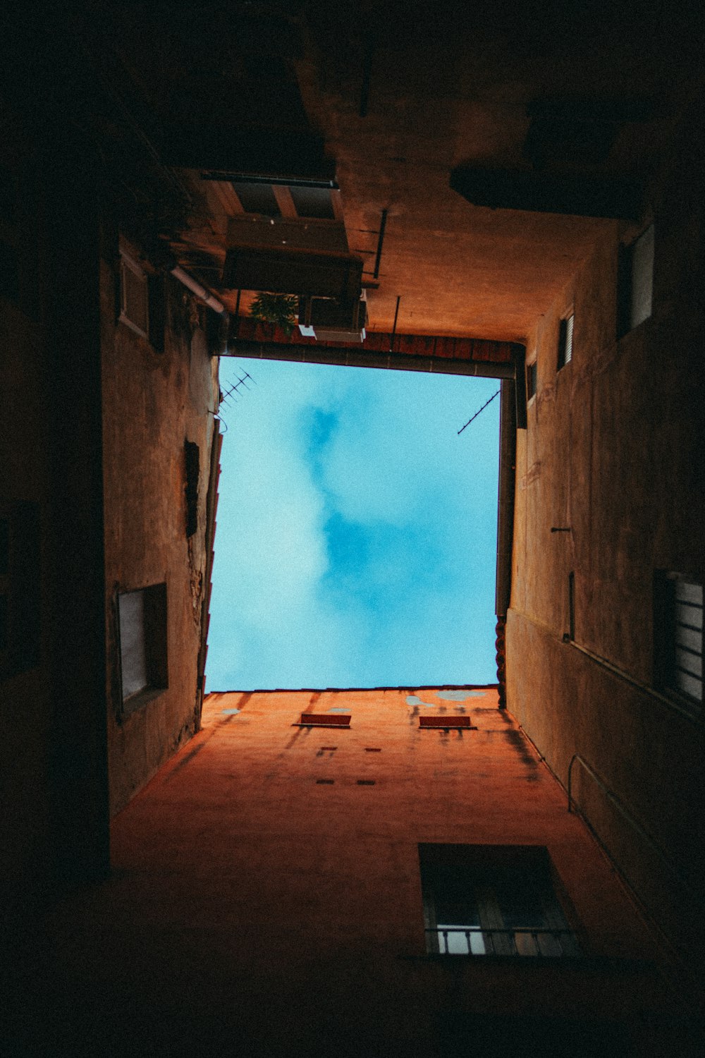 an open door leading to a sky filled with clouds