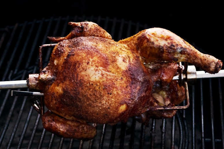 a whole chicken is cooking on a grill