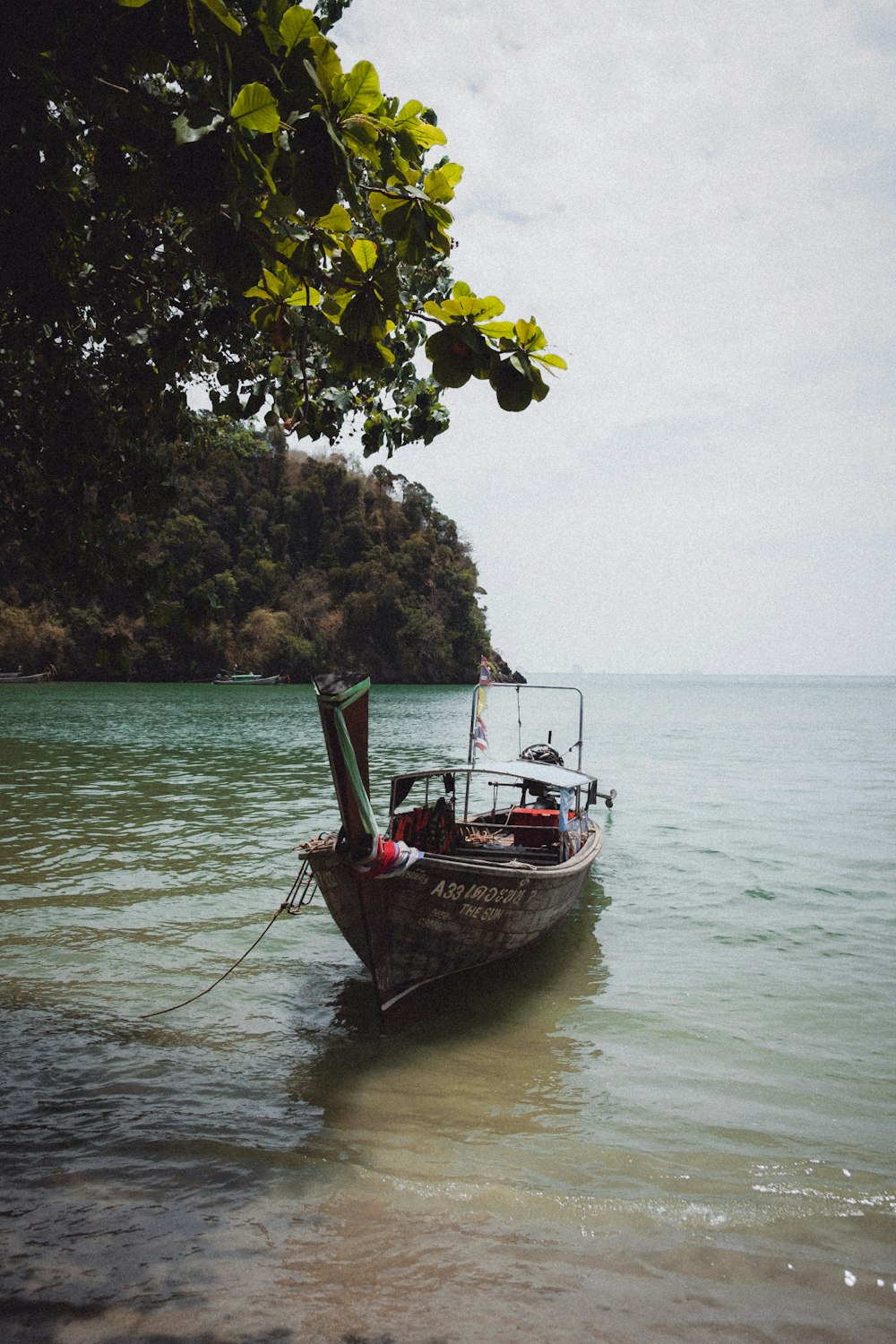 a small boat floating on top of a body of water