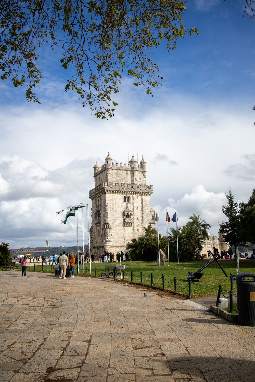 a tall white tower sitting on top of a lush green field