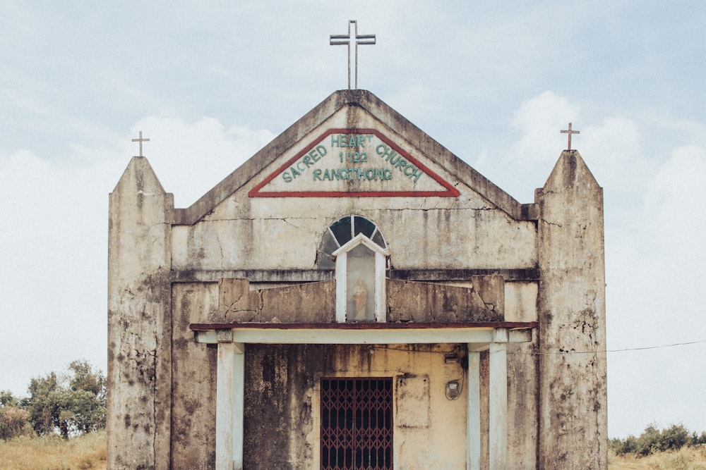 an old church with a cross on top of it