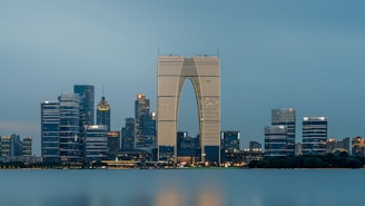 a city skyline with skyscrapers and a body of water