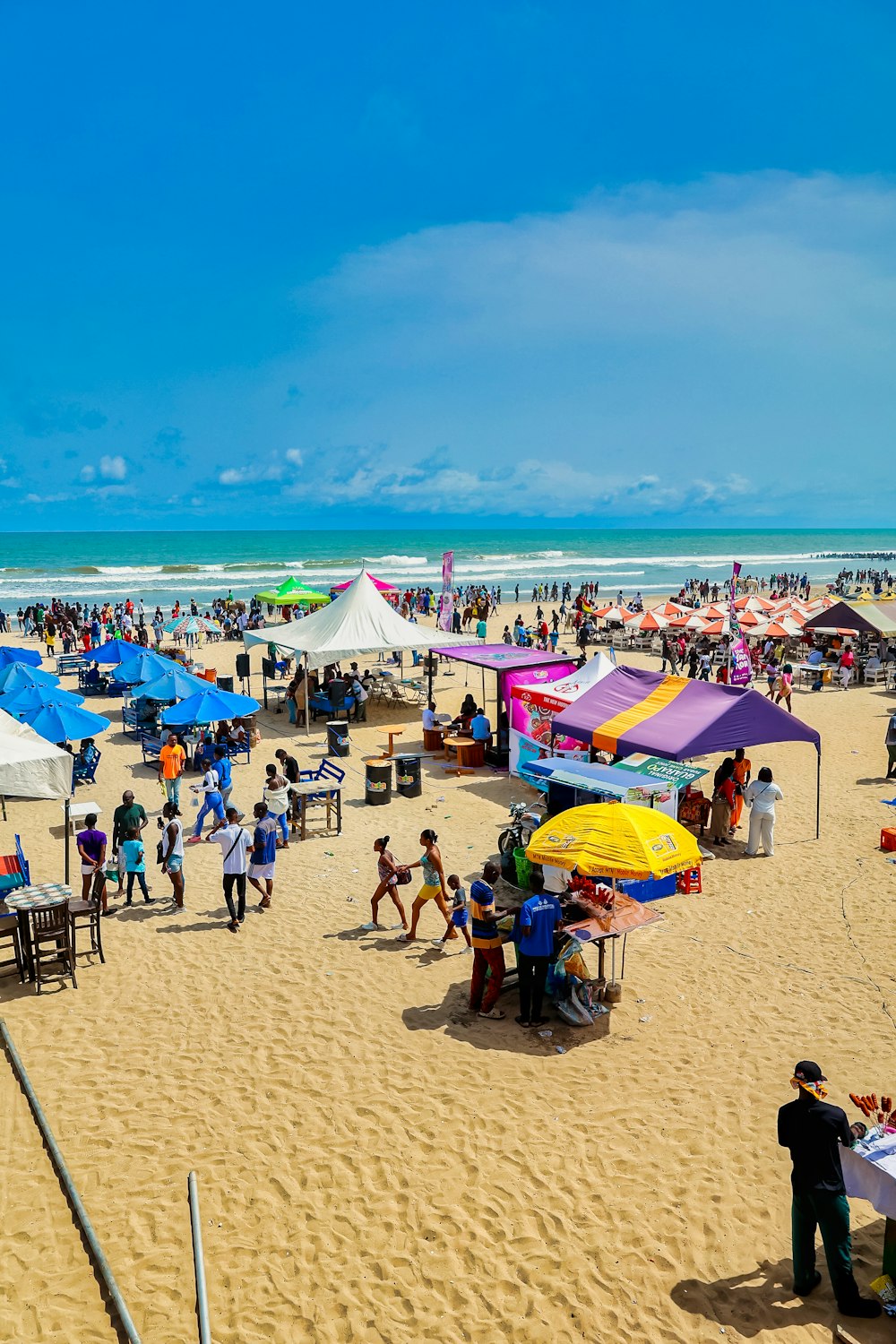 a beach filled with lots of people and umbrellas