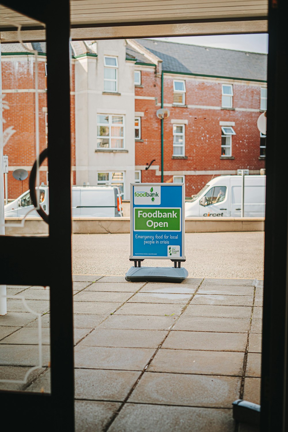 a blue sign sitting on the side of a road