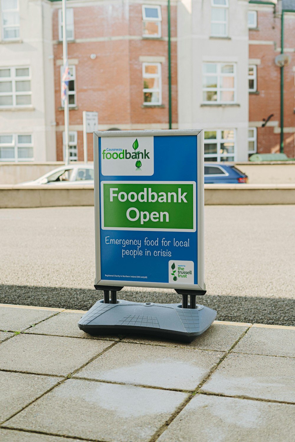 Un letrero de apertura de un banco de alimentos en una acera
