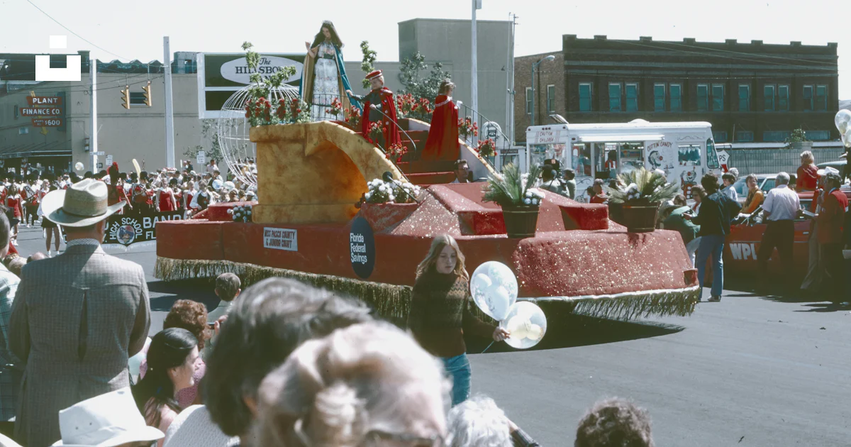 A parade float in a parade with people watching photo – Free Vintage ...