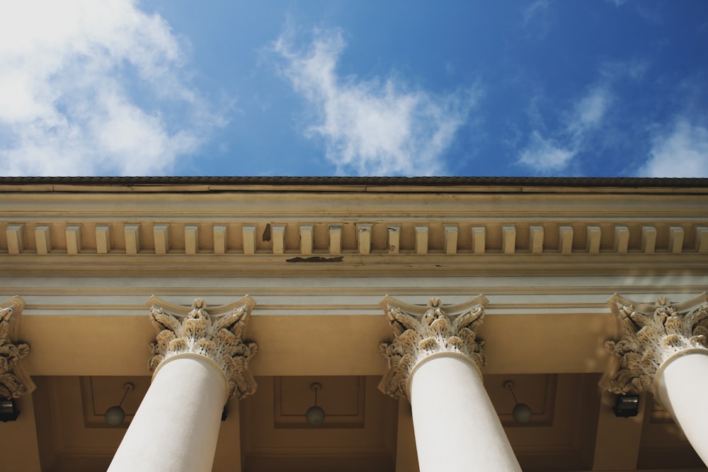 a row of white pillars with a blue sky in the background