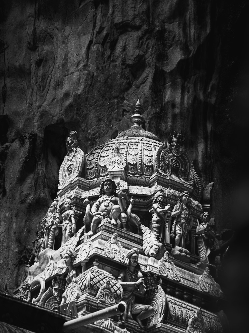 a black and white photo of a building with statues on it