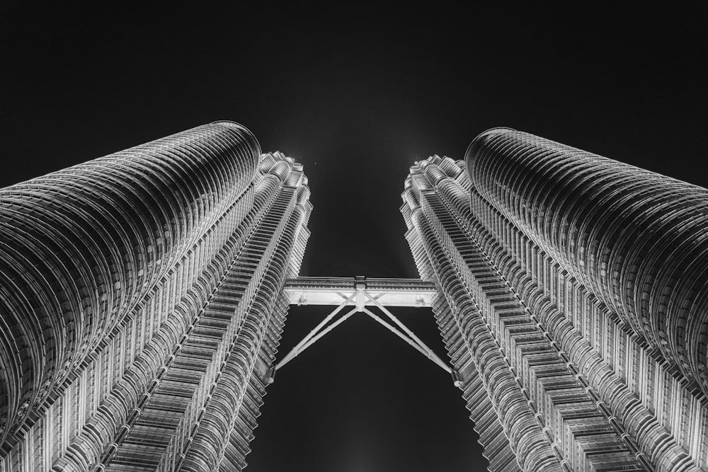 a black and white photo of two tall buildings