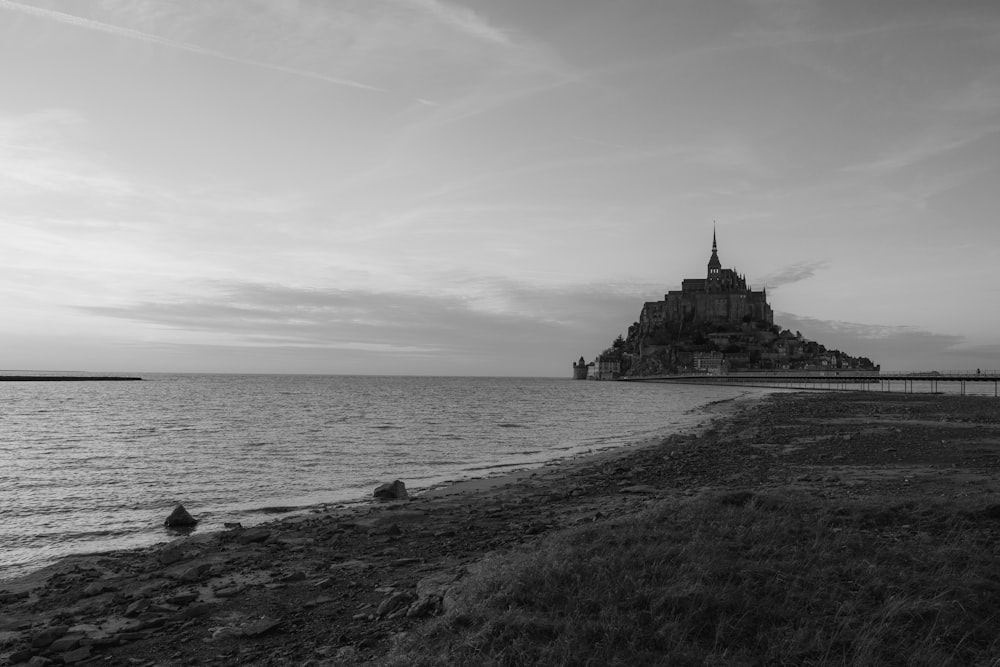 a black and white photo of an island in the ocean