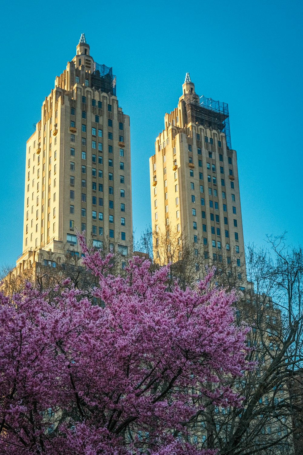 a couple of tall buildings sitting next to each other