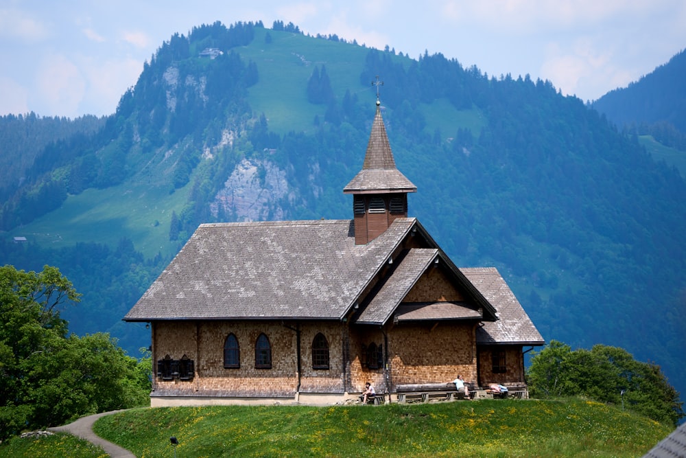 a church on a hill with mountains in the background