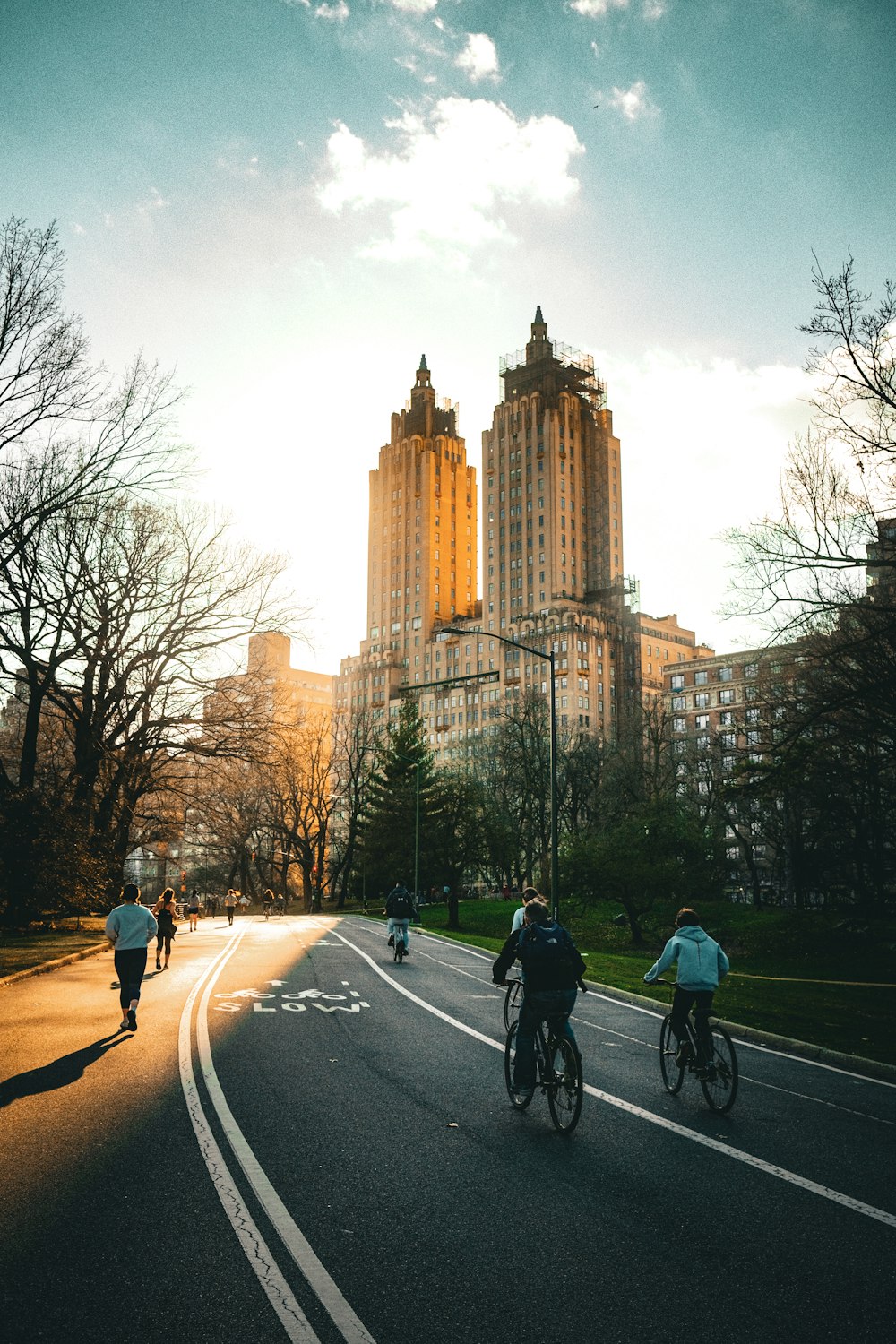 a group of people riding bikes down a street