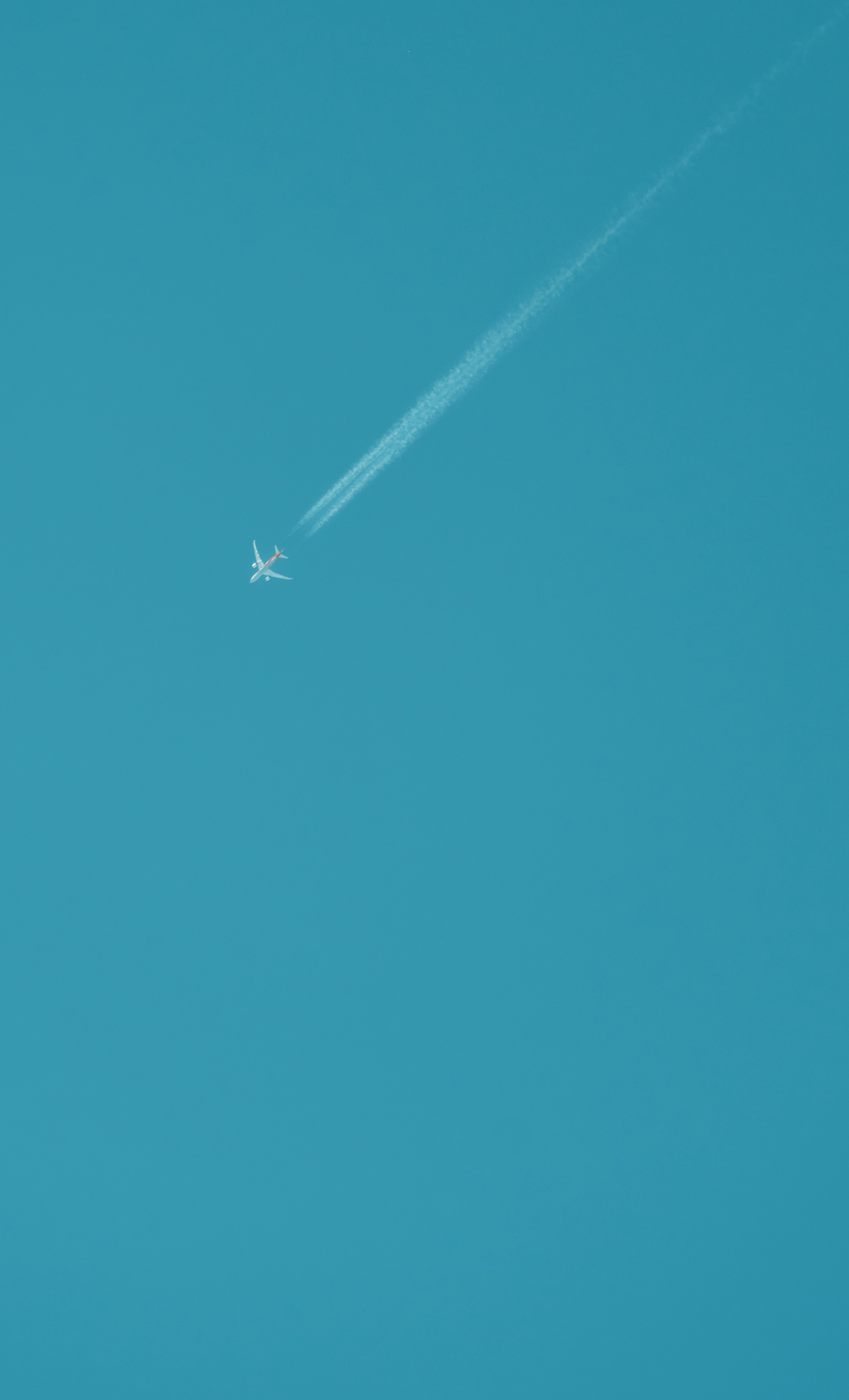 an airplane is flying high in the sky