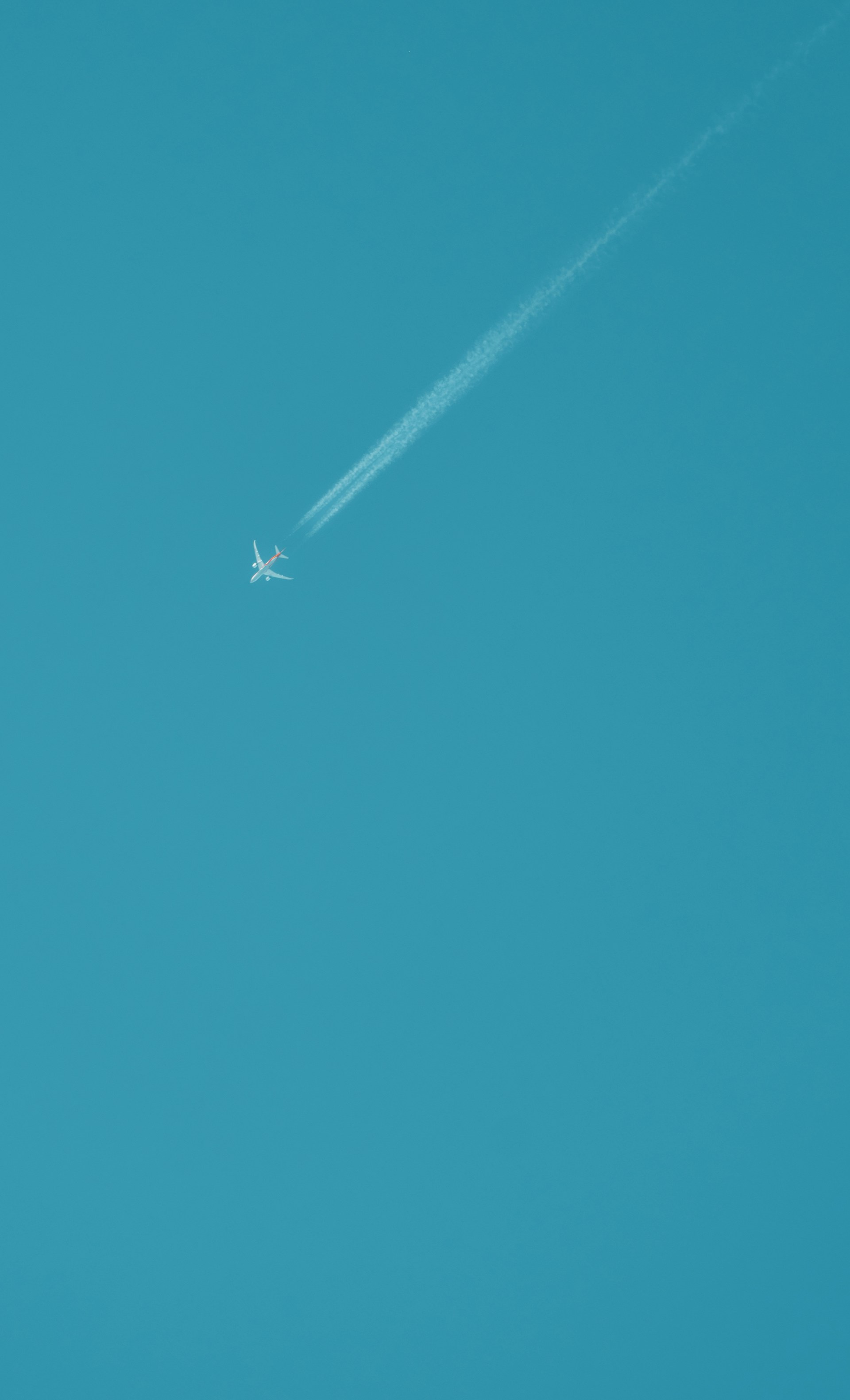 an airplane is flying high in the sky