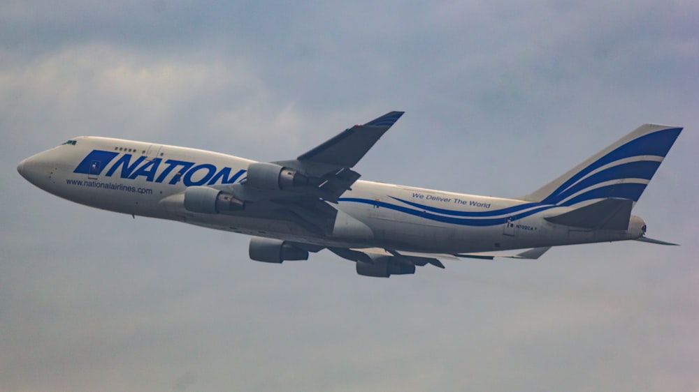 a large jetliner flying through a cloudy sky