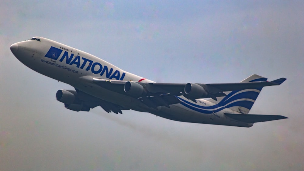 a large jetliner flying through a blue sky