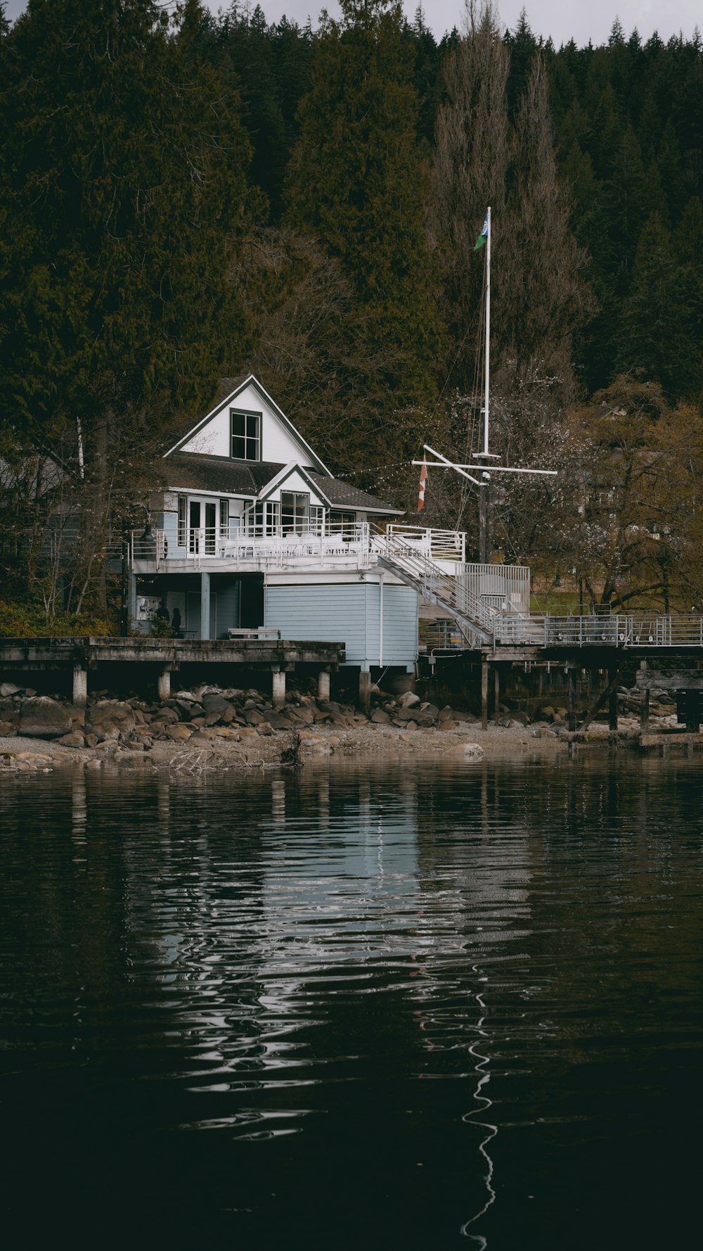 a house sitting on the edge of a body of water