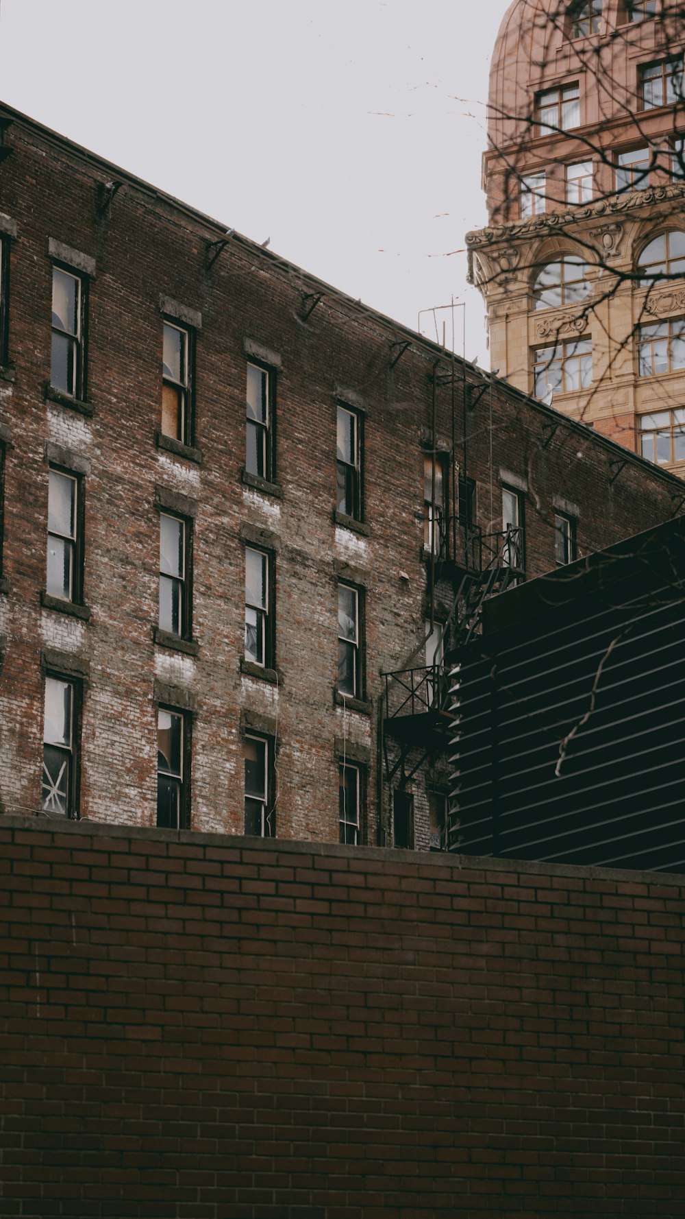 a man riding a skateboard down the side of a brick wall