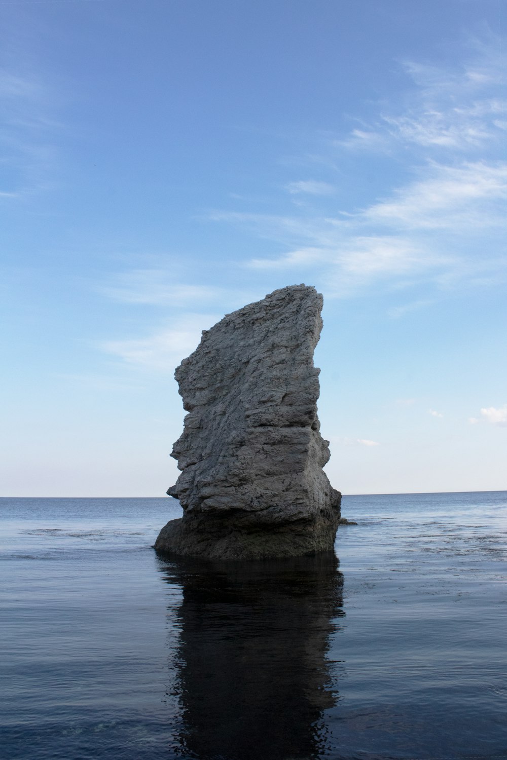 a large rock sticking out of the water