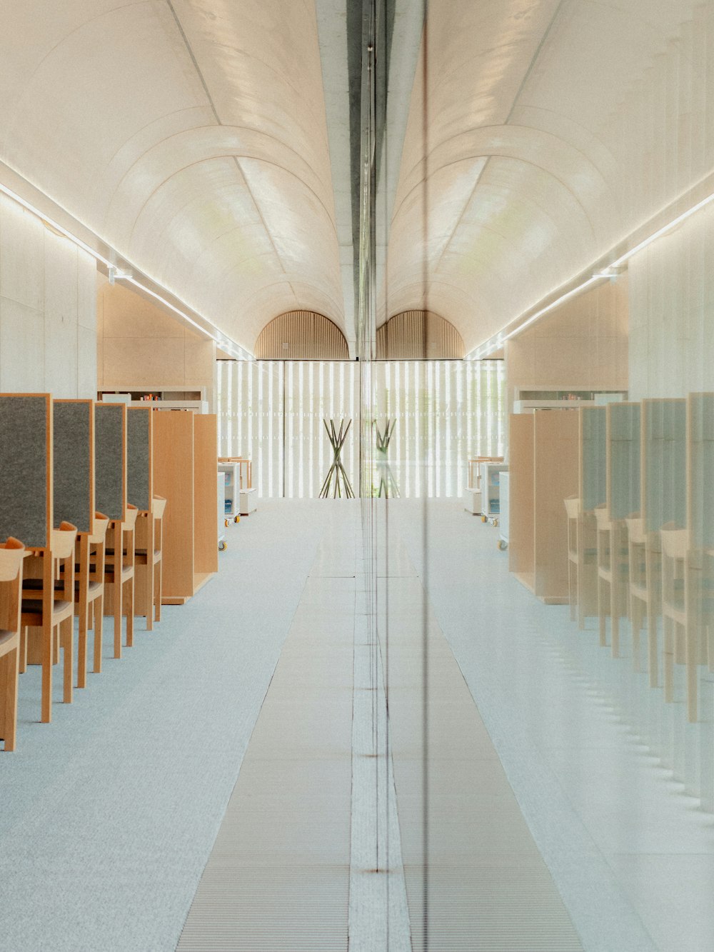 a room filled with lots of wooden chairs