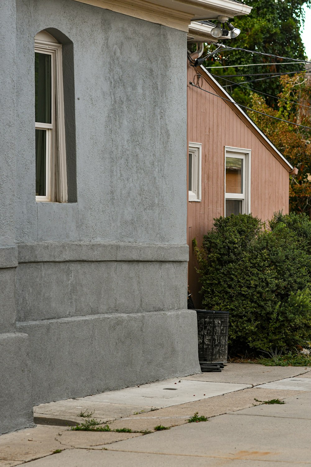 a red fire hydrant sitting on the side of a sidewalk