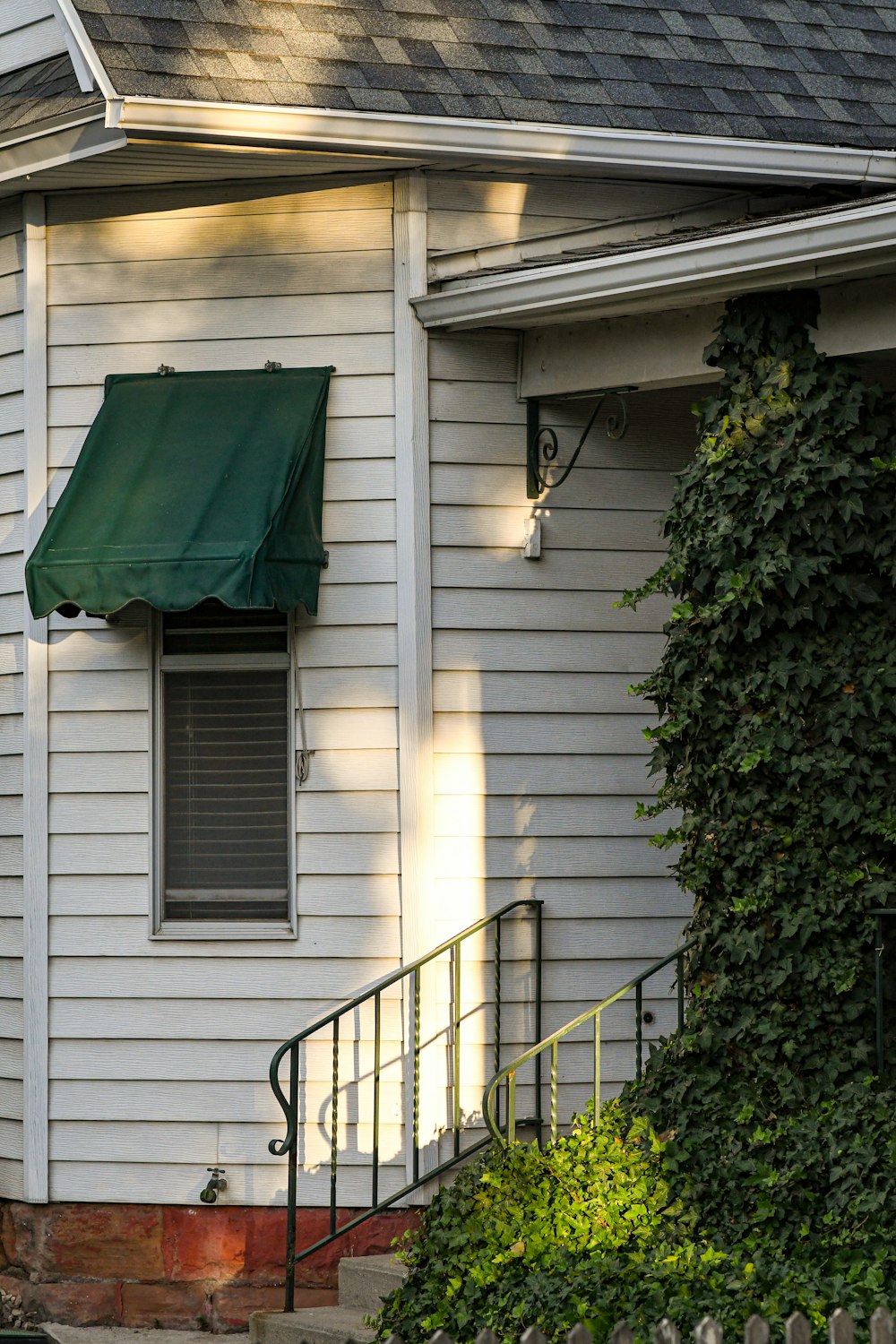 a white house with a green awning