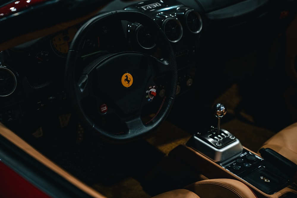 the interior of a car with a steering wheel and dashboard