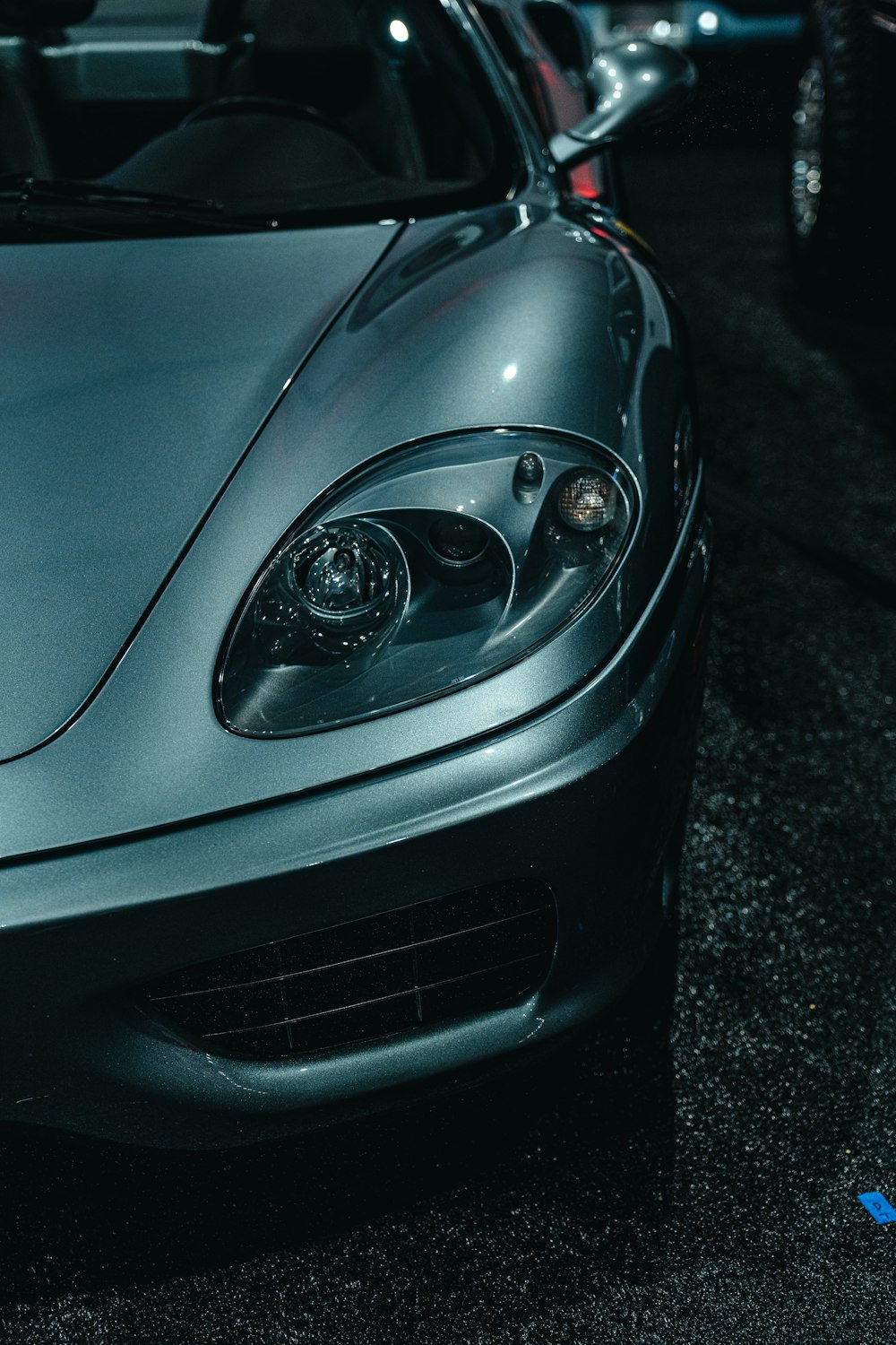 a silver sports car parked in a parking lot