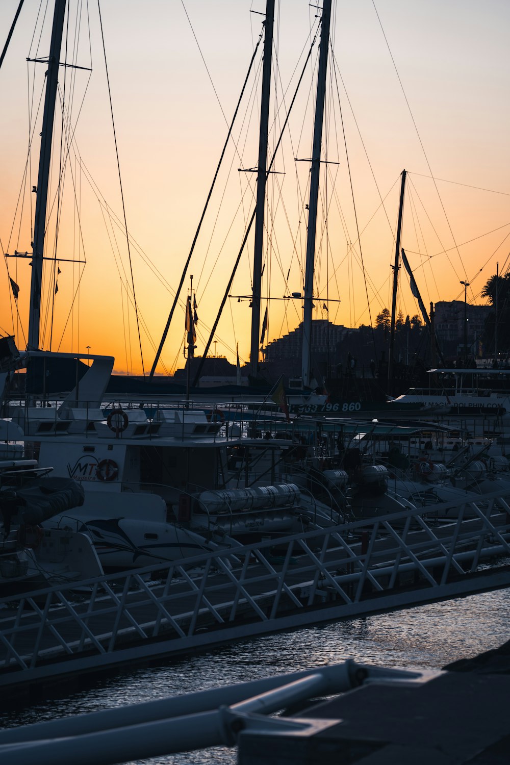 a harbor filled with lots of boats at sunset