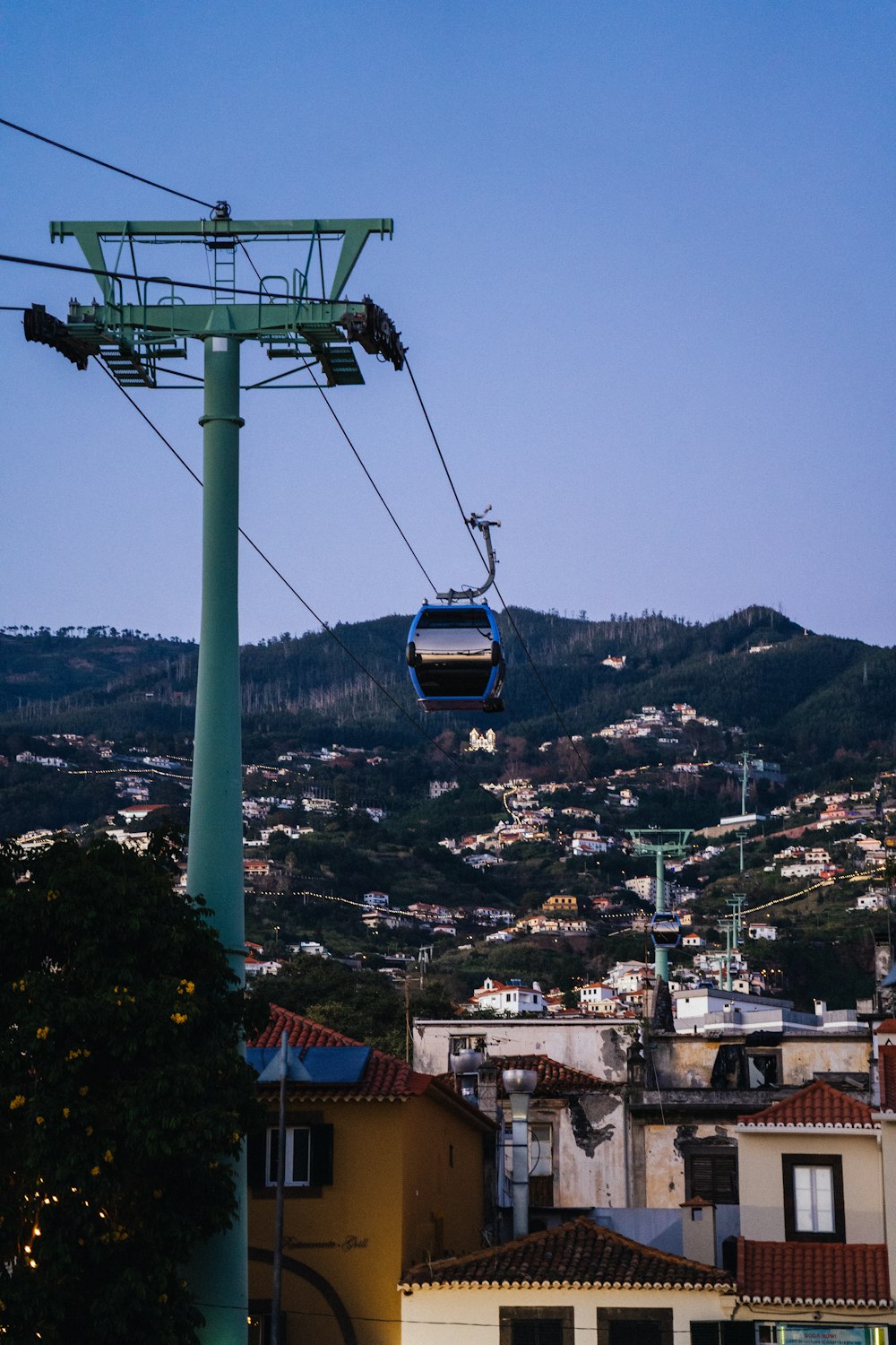 a cable car going up a hill with a city in the background