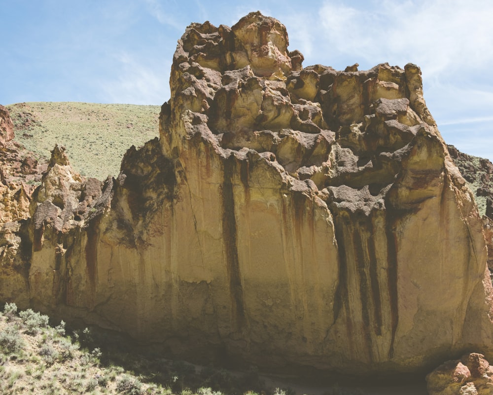 a large rock formation in the middle of a desert