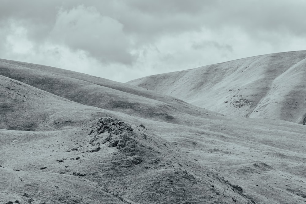 a black and white photo of a hilly area