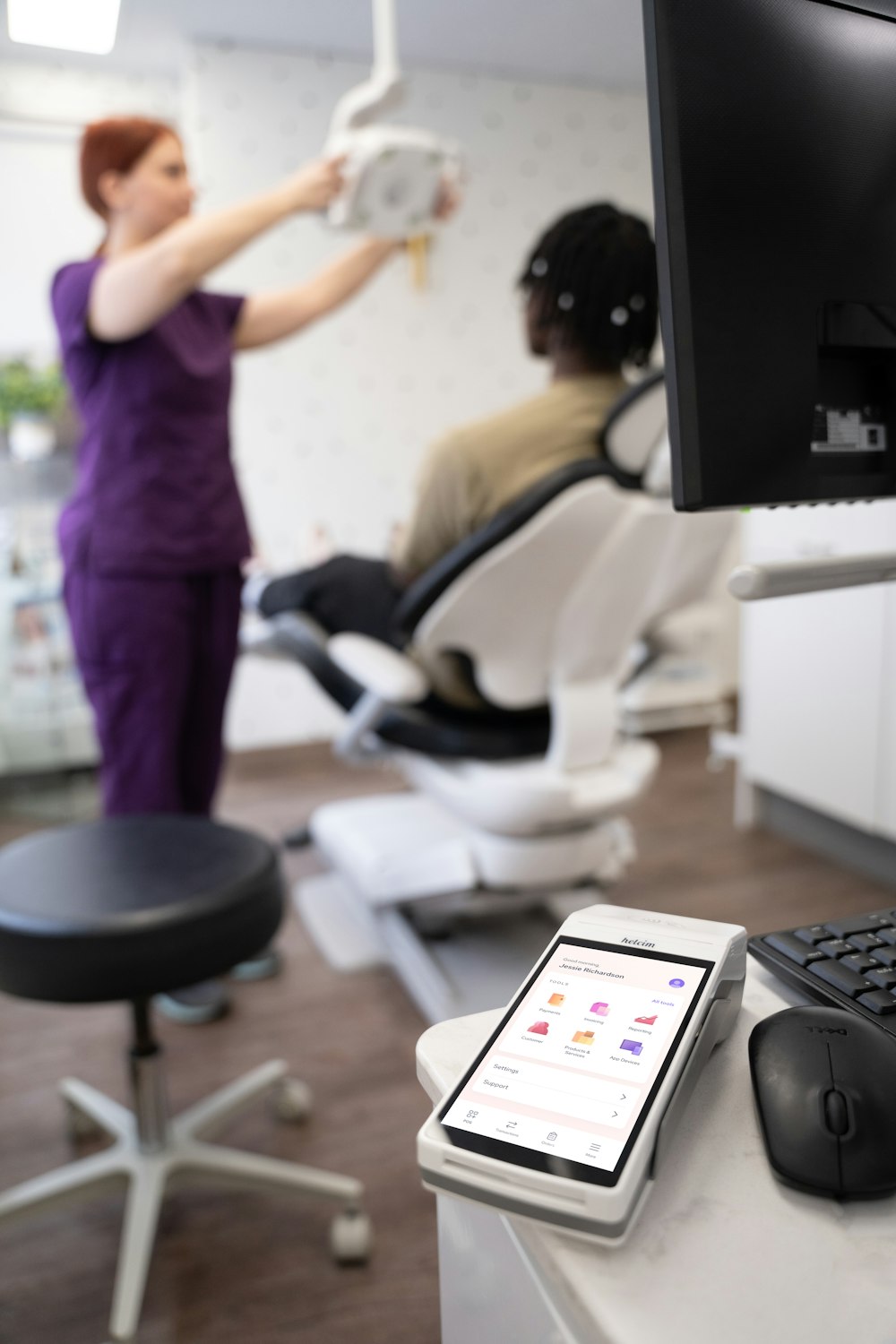 a woman in a hair salon holding a hair dryer