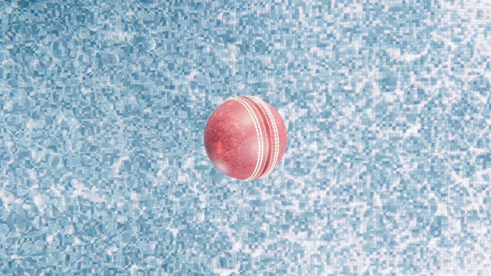 a red object floating in a pool of water