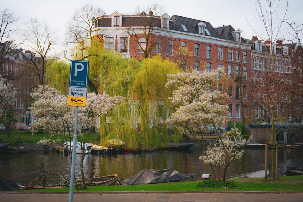 a street sign in front of a body of water