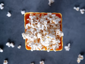 a bowl filled with popcorn sitting on top of a table